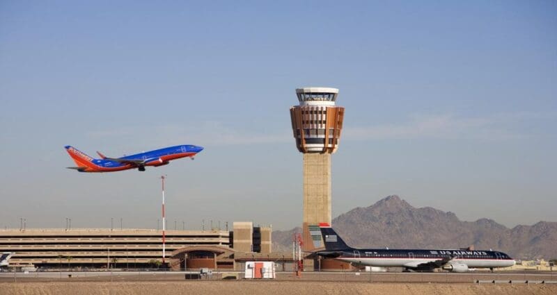 Arport control tower and plane takeoff