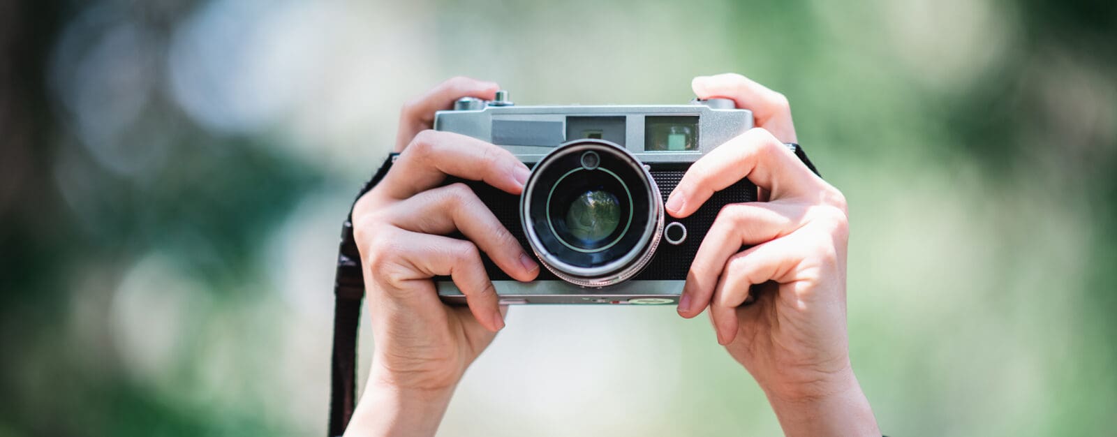 Hands of Female Professional photographer takes snapshots in for