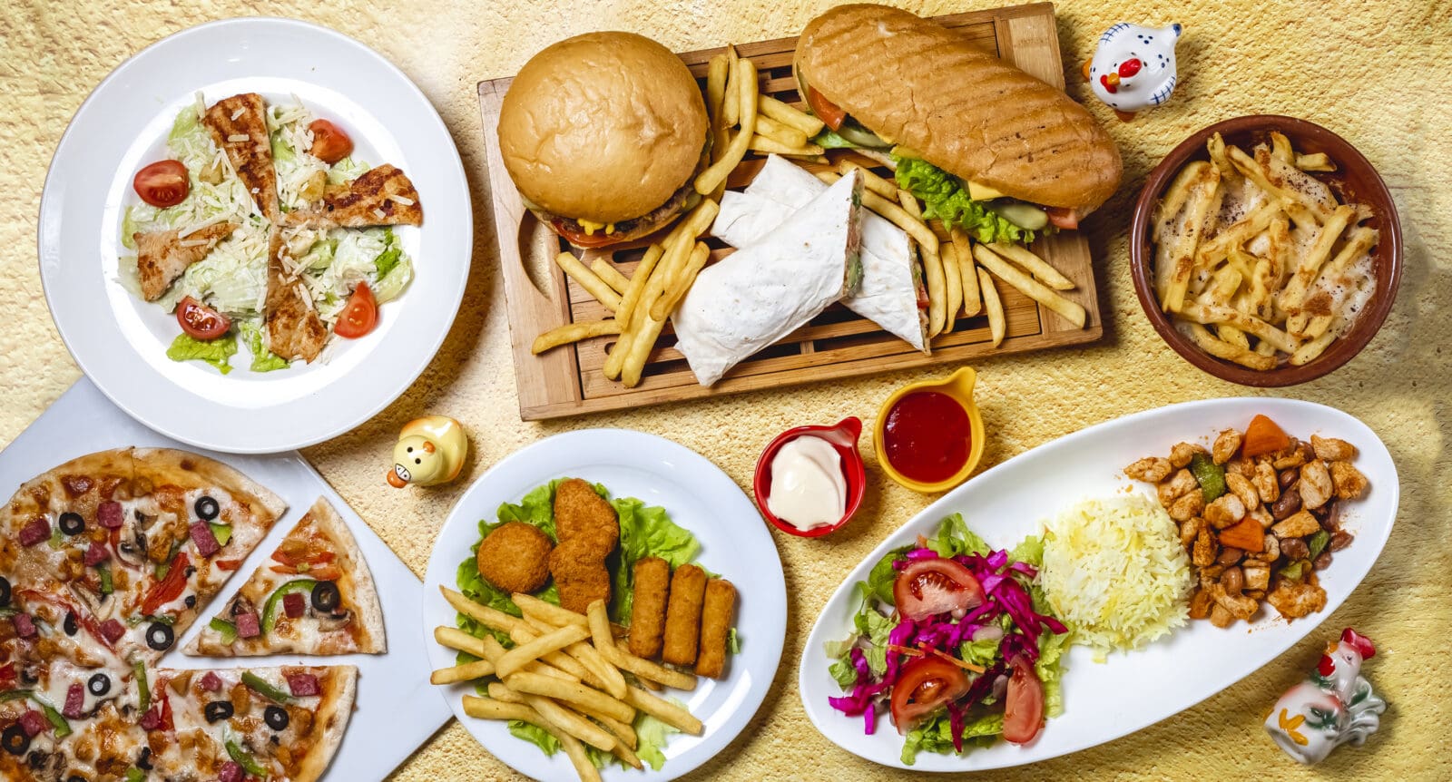 top view fast food mix hamburger doner sandwich chicken nuggets rice vegetable salad chicken sticks caesar salad mushrooms pizza chicken ragout french fries mayo a