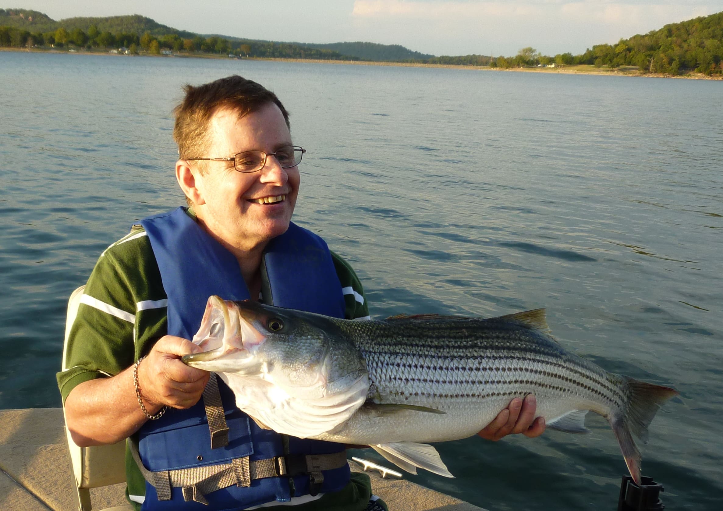 Handicapped man in wheelchair holding a fish | Special Journeys | Vacations for People with Disabilities